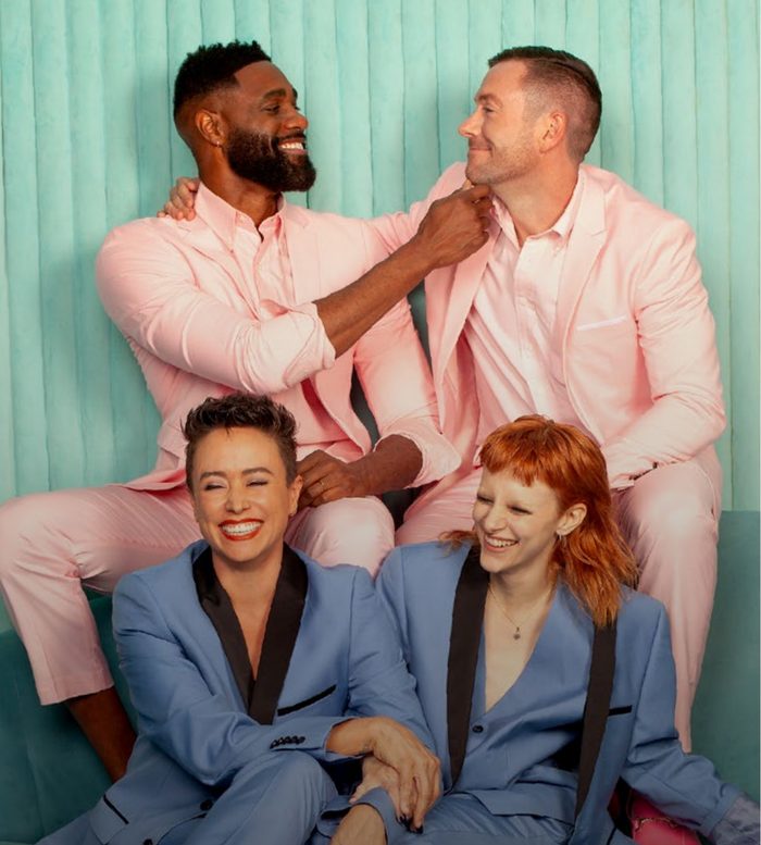 Four LGBTQ+ friends in pastel suits laughing together, from Revry's 2026 advertiser overview